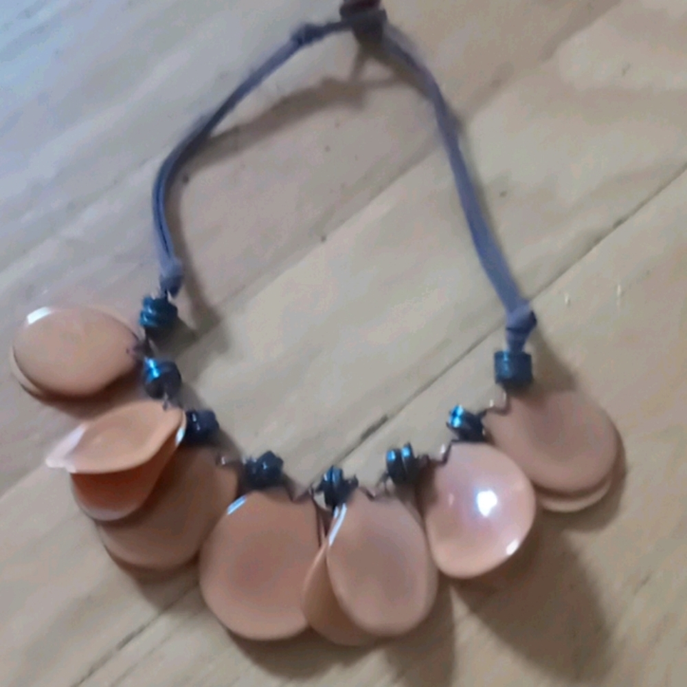 Peach colored oval choker on adjustable leather